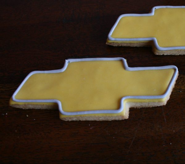 Yellow chevy logo cookies with grey outline